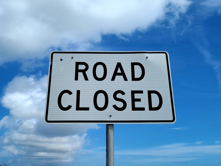 road closed sign with blue sky background